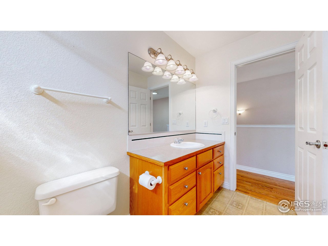 3585 West 20th Street Road Greeley, CO 80634 - Photo 7 of 32 a bathroom with a sink a vanity and a mirror