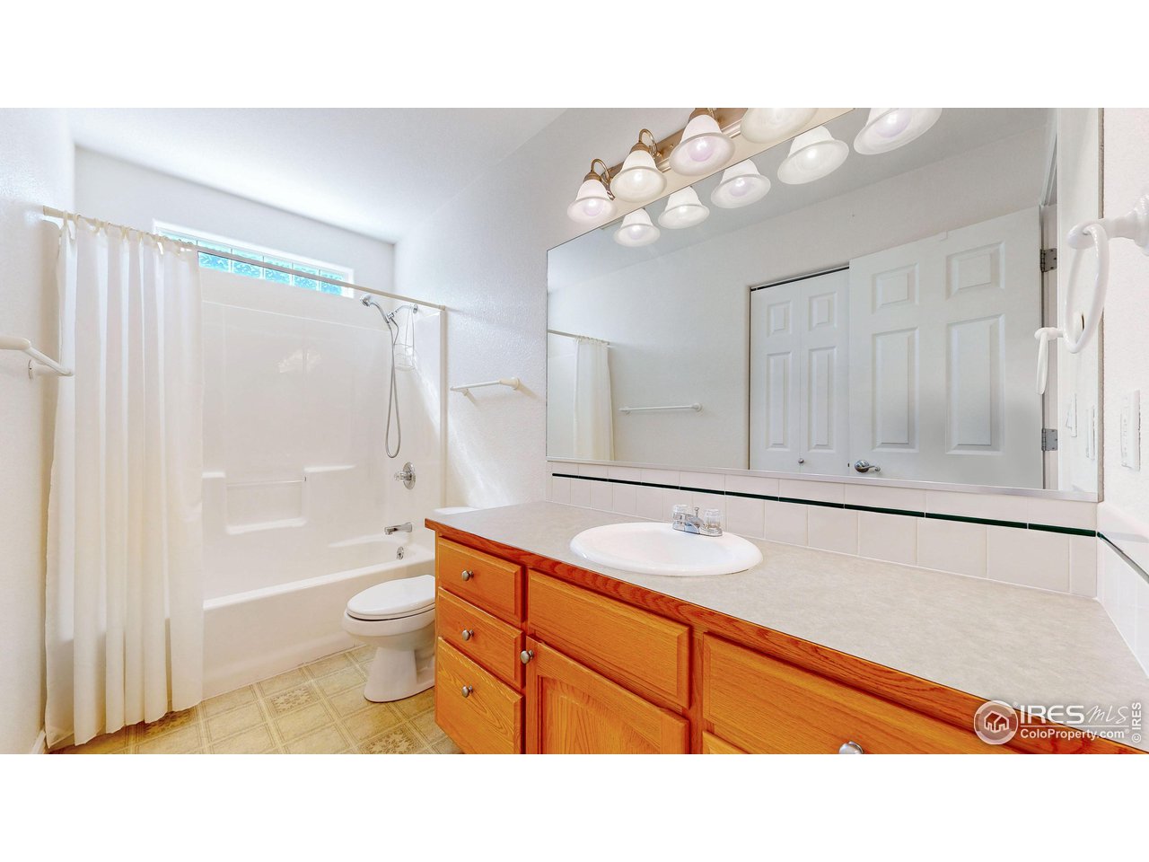 3585 West 20th Street Road Greeley, CO 80634 - Photo 8 of 32 a bathroom with a sink a toilet and bathtub