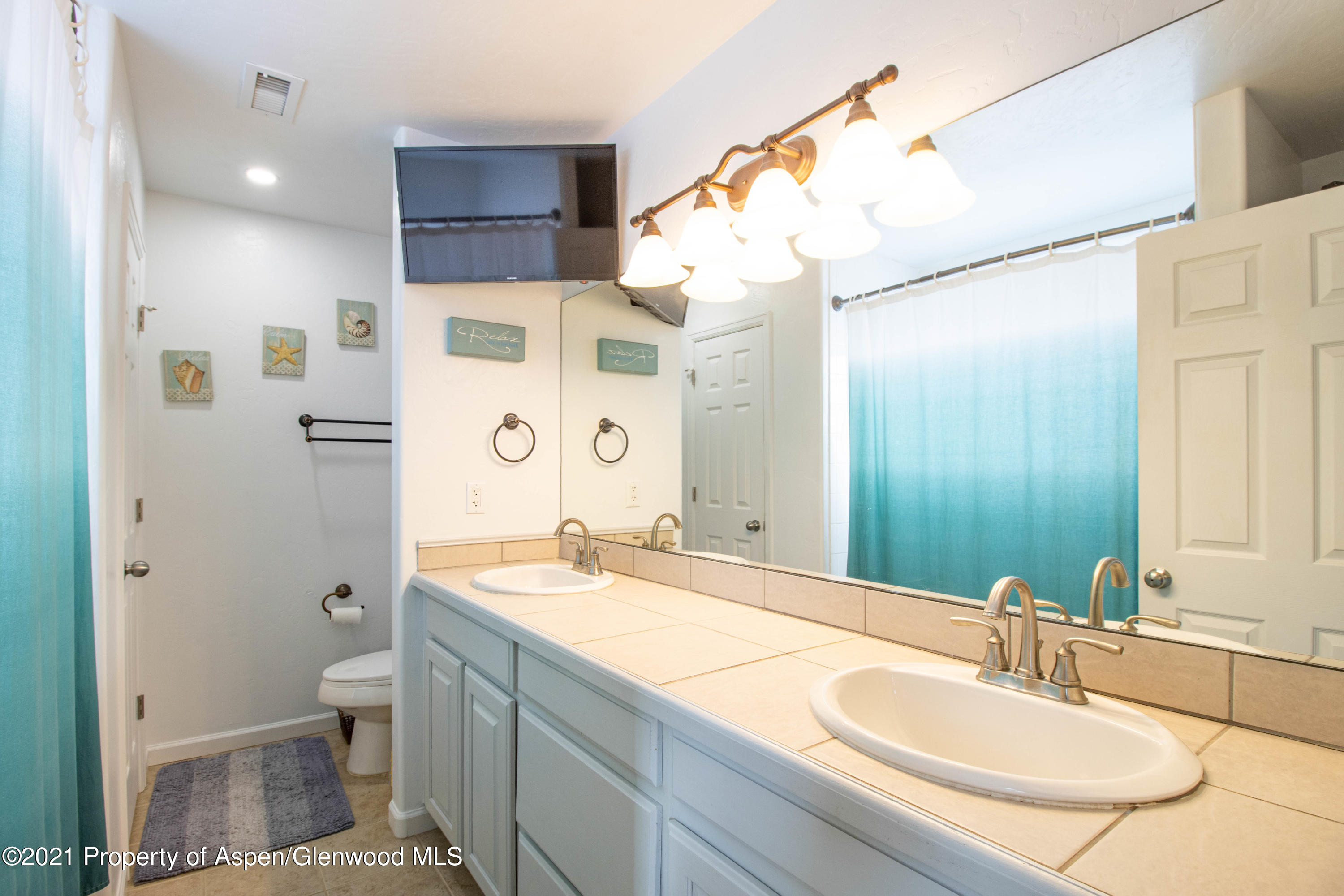 1259 East 18th Way Rifle, CO 81650 - Photo 14 of 17 a bathroom with a granite countertop sink toilet and shower