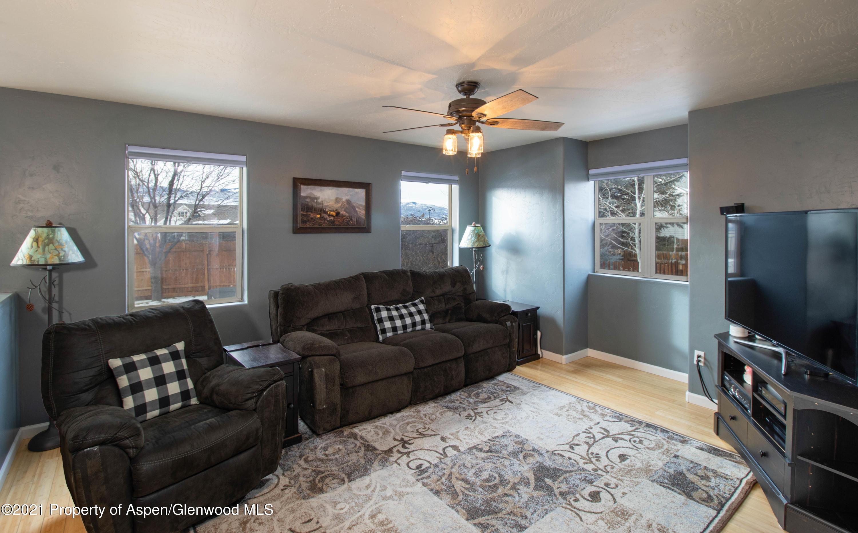1259 East 18th Way Rifle, CO 81650 - Photo 6 of 17 a living room with furniture a flat screen tv and a window