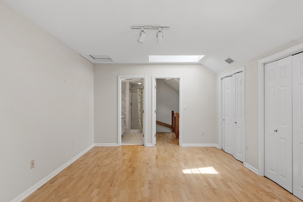 31 Pointe Rok Drive, Unit 31 Worcester, MA 01604 - Photo 21 of 32 a view of a room with wooden floor and a ceiling fan