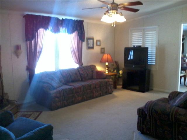 70 Ballenger Road Carthage, TN 37030 - Photo 2 of 11 This is the formal den with wood burning fireplace. This den and the three extra bedrooms are on the opposite end of the house from the master bedroom and living room. Lots of room to spread out!