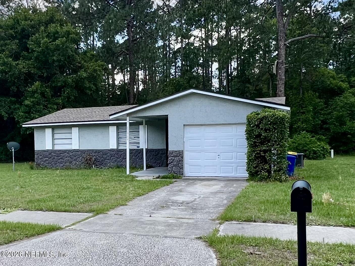 10964 Bacall Road West Jacksonville, FL 32218 - Photo 2 of 19 a front view of a house with garden