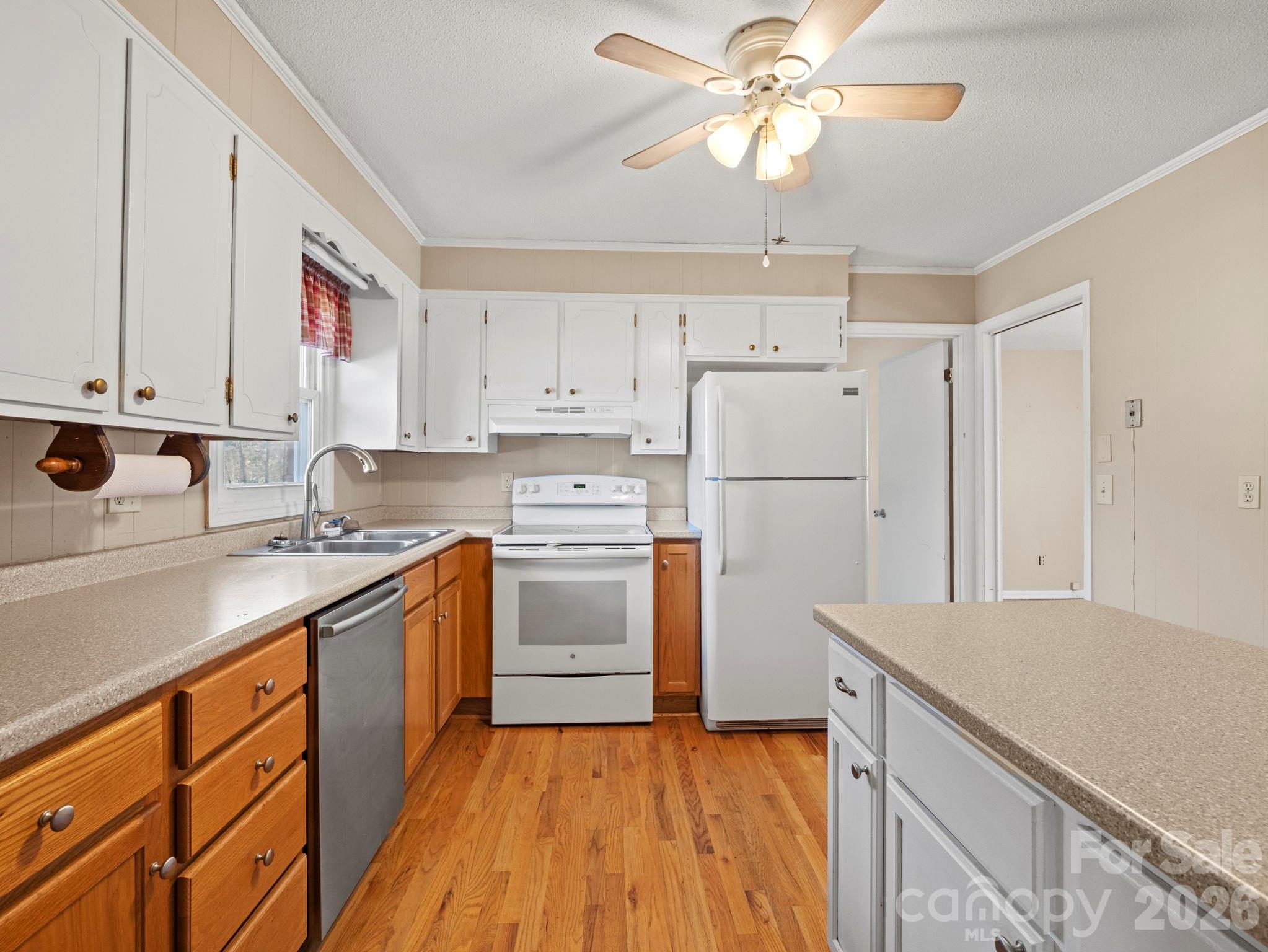 1429 Doggett Road Forest City, NC 28043 - Photo 12 of 33 a kitchen with cabinets stainless steel appliances and a window