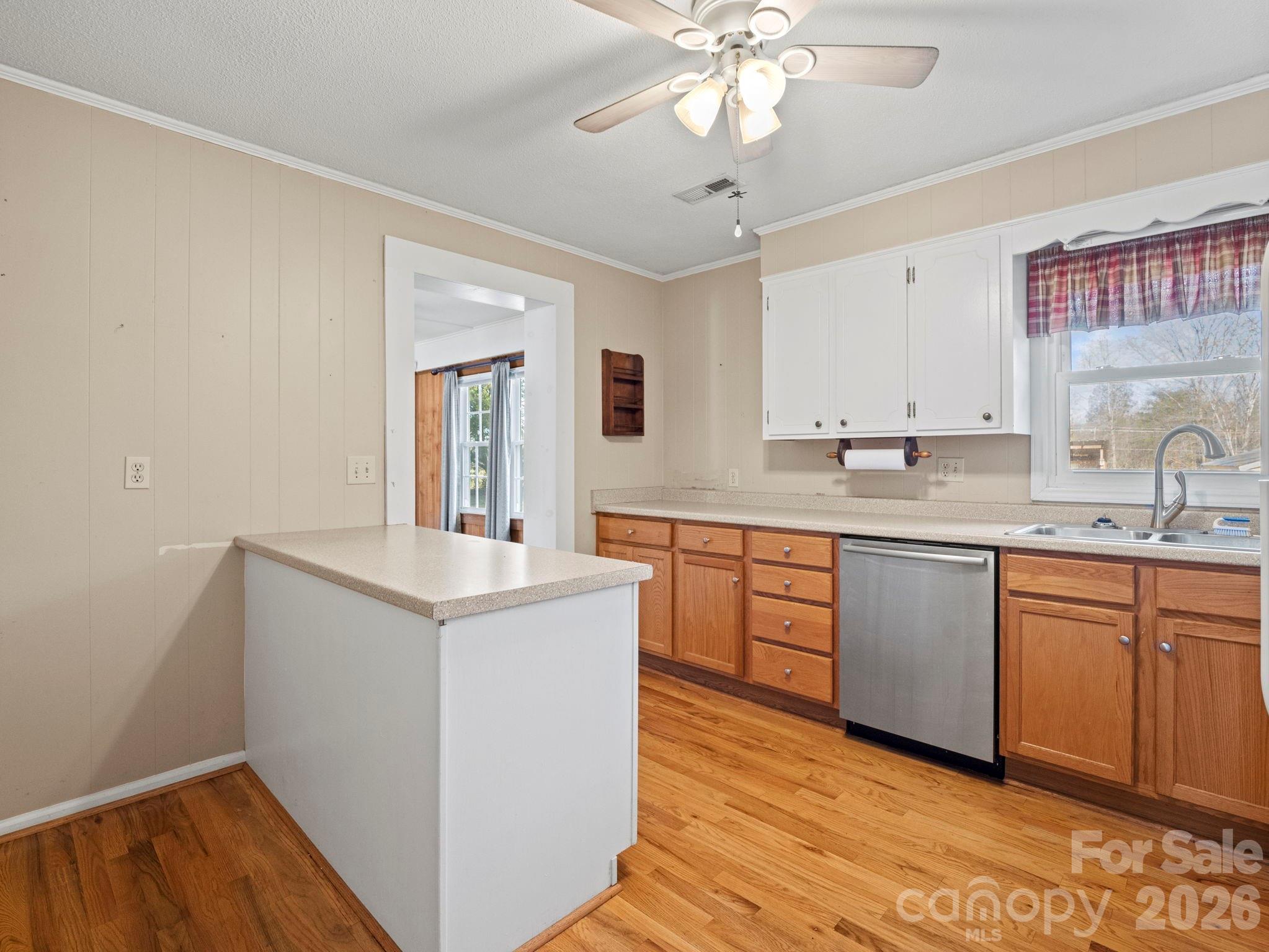 1429 Doggett Road Forest City, NC 28043 - Photo 14 of 33 a kitchen with a sink cabinets and wooden floor