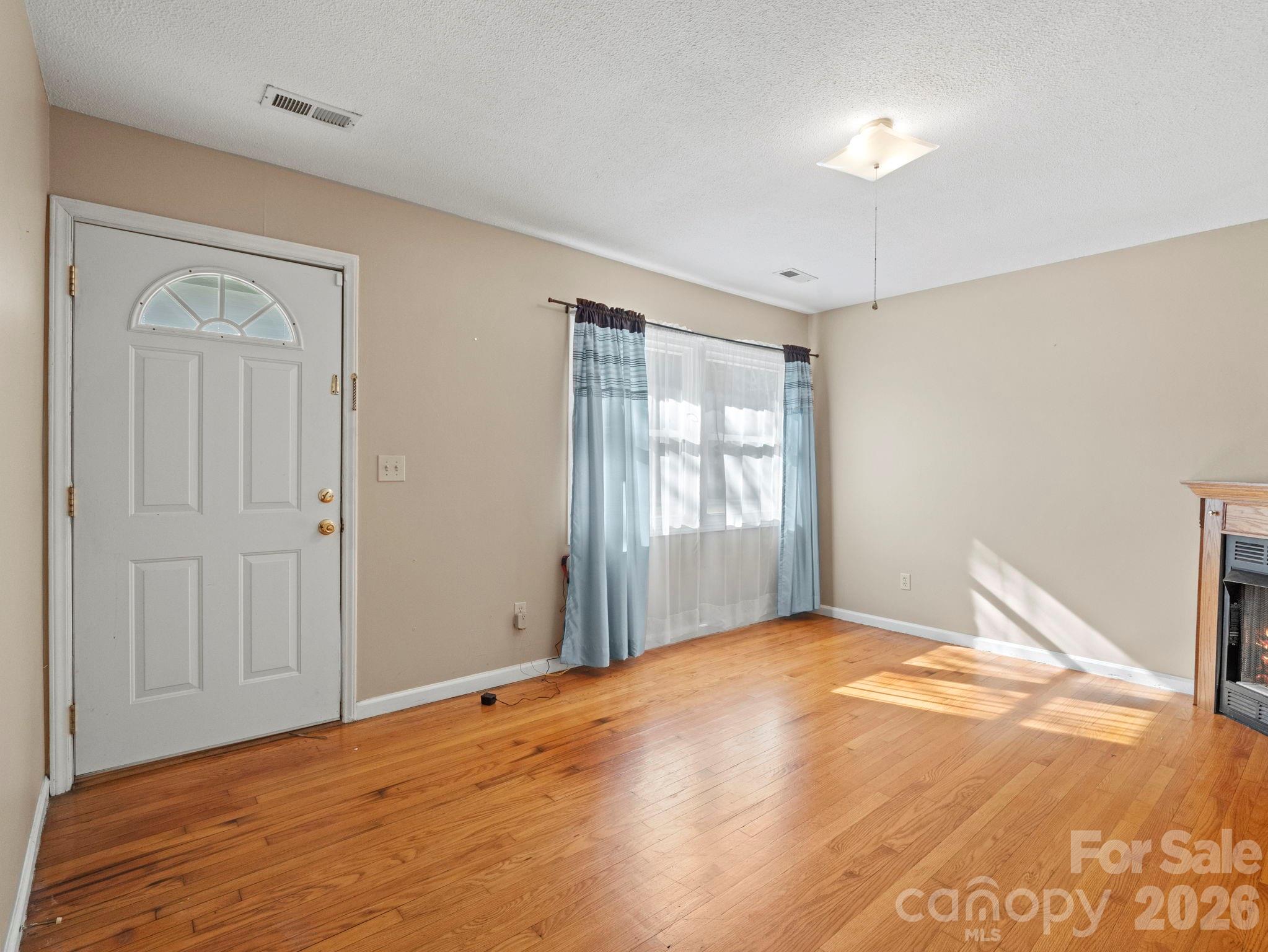 1429 Doggett Road Forest City, NC 28043 - Photo 15 of 33 a view of empty room with window and wooden floor