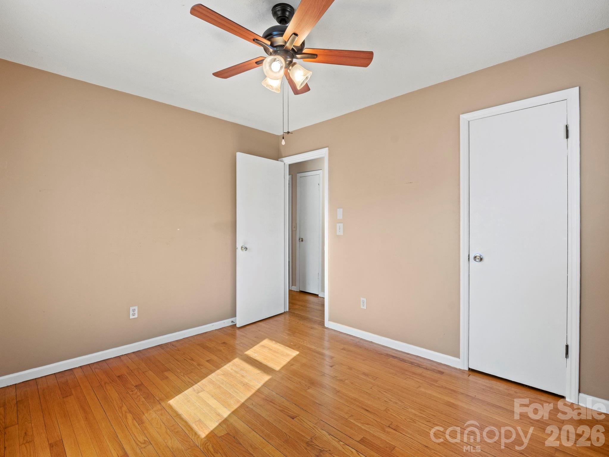 1429 Doggett Road Forest City, NC 28043 - Photo 17 of 33 a view of a room with wooden floor and a ceiling fan