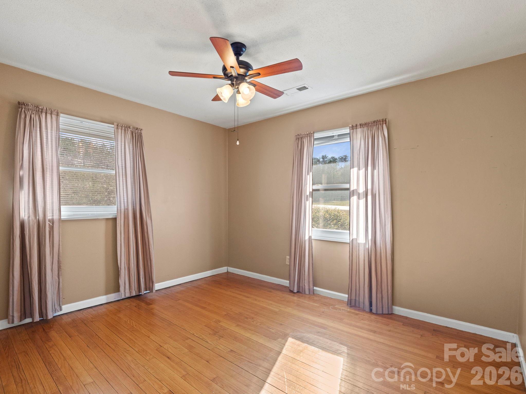 1429 Doggett Road Forest City, NC 28043 - Photo 20 of 33 a view of a big room with wooden floor and windows in a room