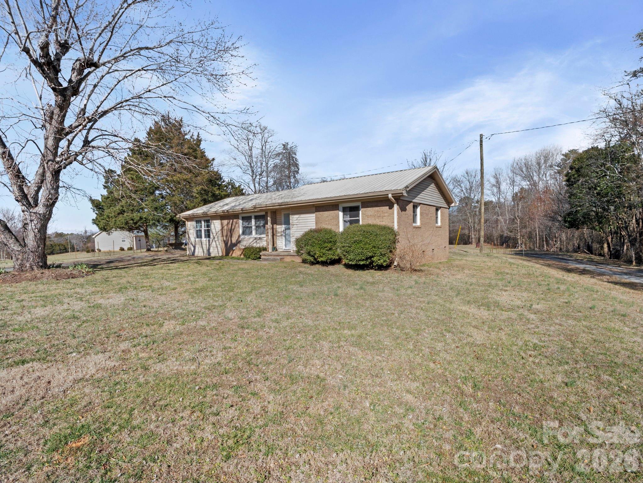 1429 Doggett Road Forest City, NC 28043 - Photo 2 of 33 a view of house with yard and trees in the background