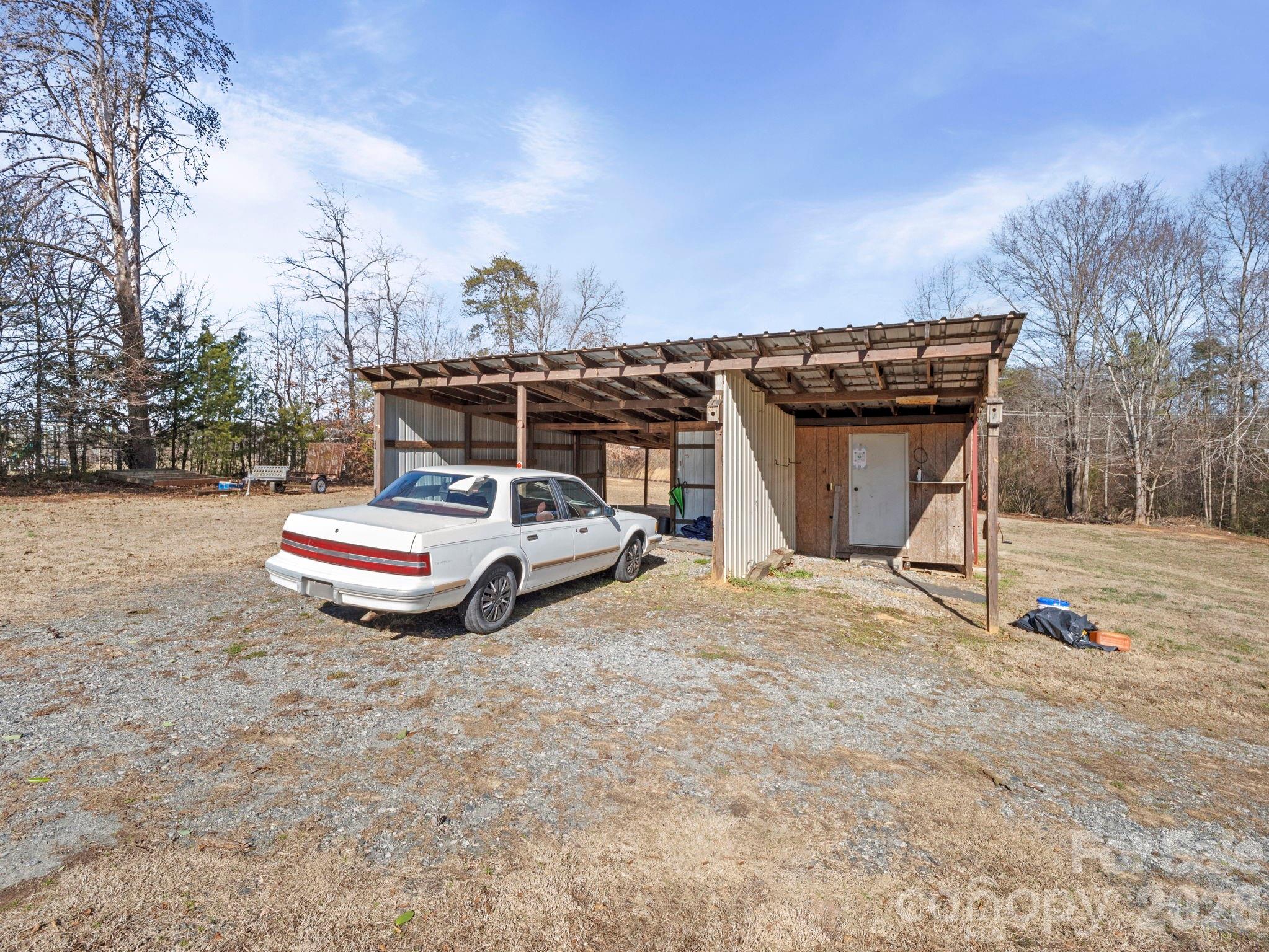 1429 Doggett Road Forest City, NC 28043 - Photo 28 of 33 a view of roof deck with a table and chairs under an umbrella
