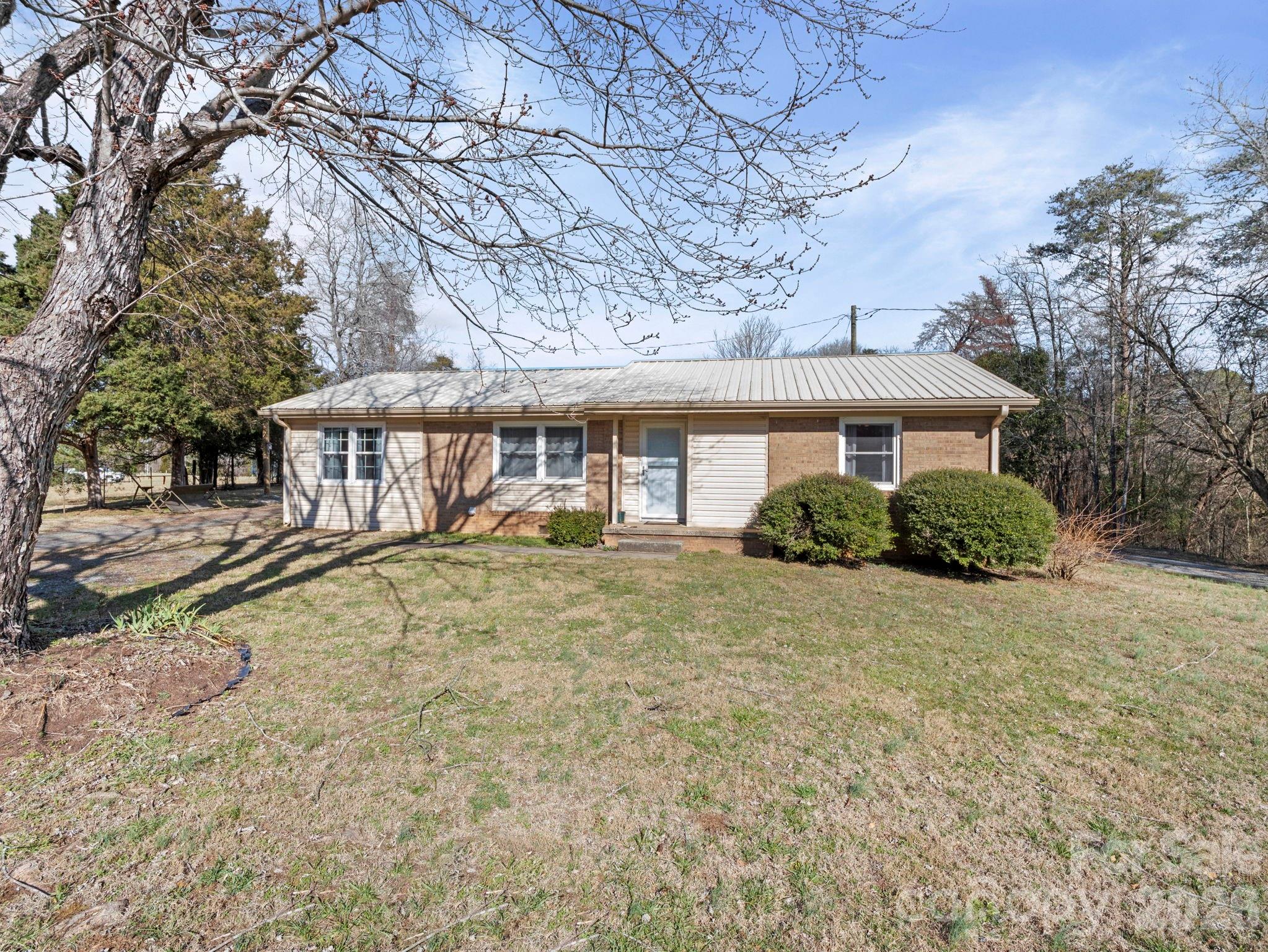 1429 Doggett Road Forest City, NC 28043 - Photo 3 of 33 a front view of a house with a yard garage and outdoor seating