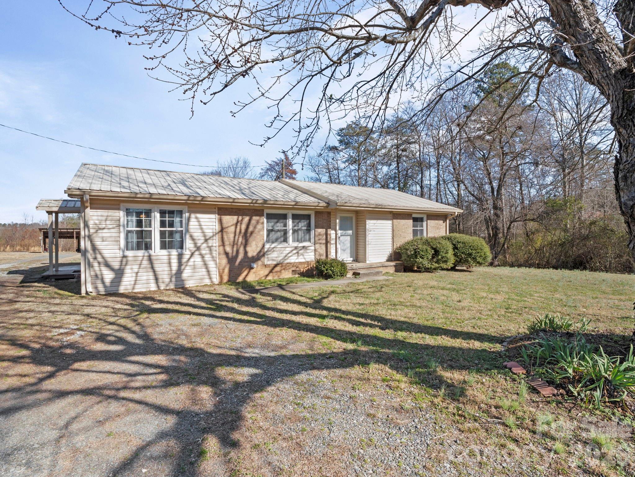 1429 Doggett Road Forest City, NC 28043 - Photo 4 of 33 a view of a house with a yard in the forest