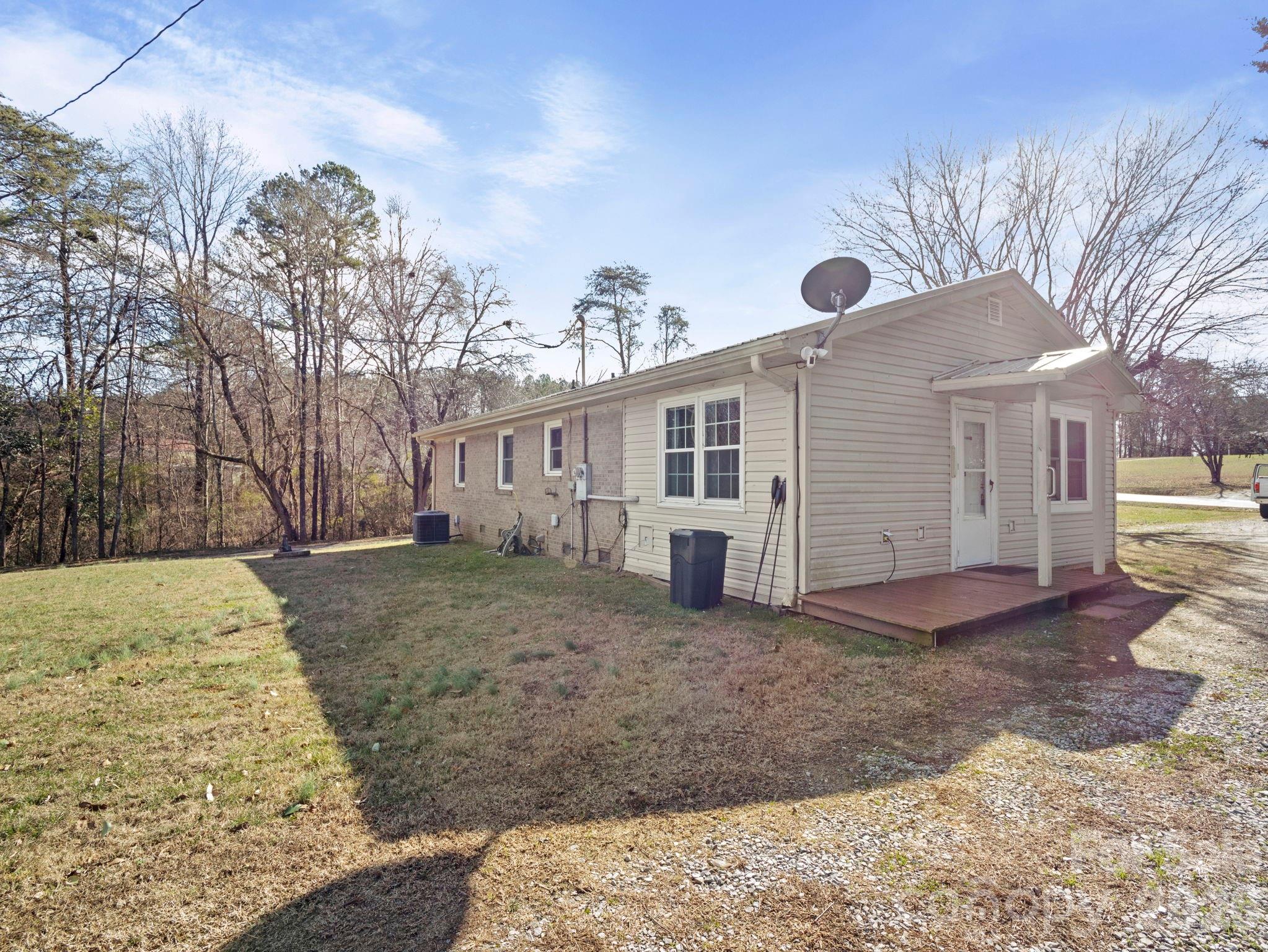 1429 Doggett Road Forest City, NC 28043 - Photo 5 of 33 a view of a grey house with a yard