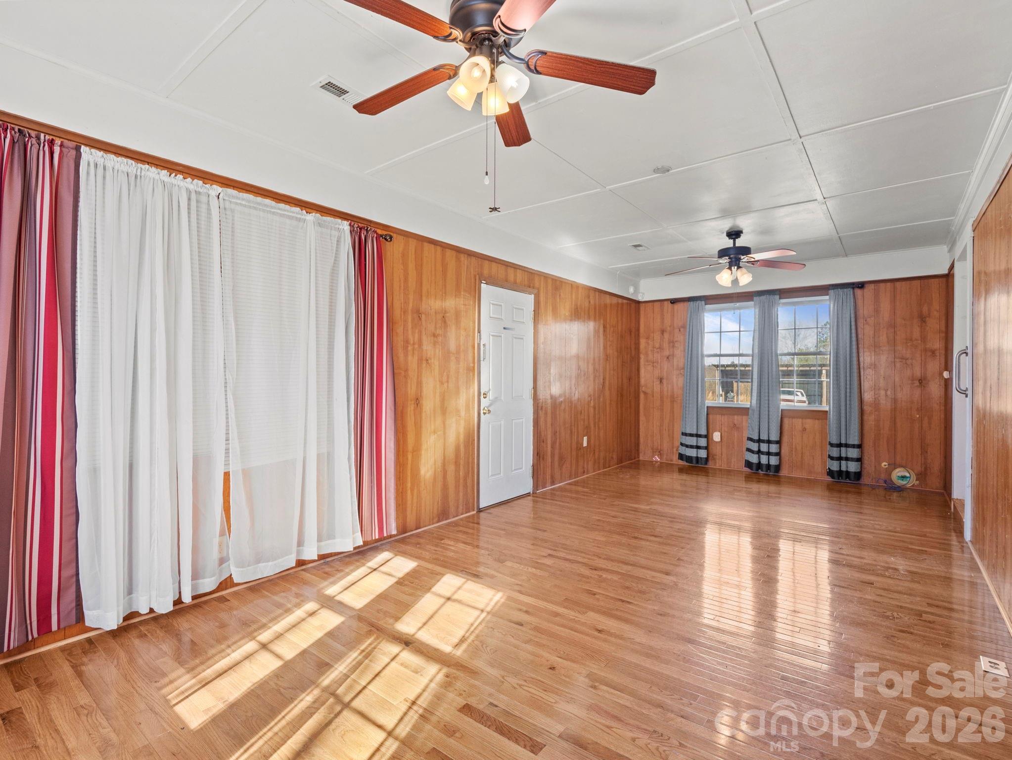 1429 Doggett Road Forest City, NC 28043 - Photo 8 of 33 a view of a livingroom with wooden floor and a ceiling fan