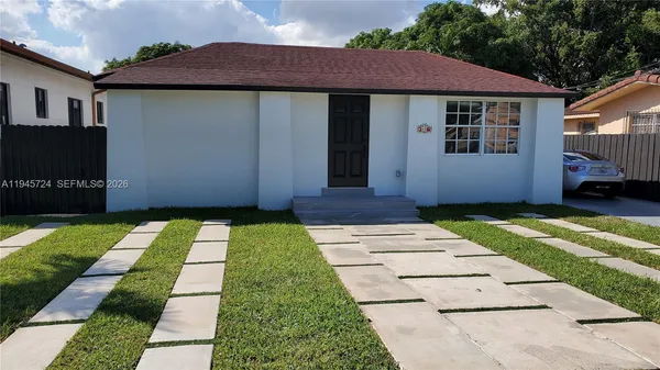 a white house with a yard