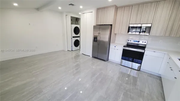 a kitchen with stainless steel appliances a refrigerator sink and microwave