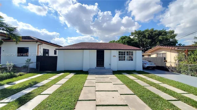 a front view of house with yard and green space