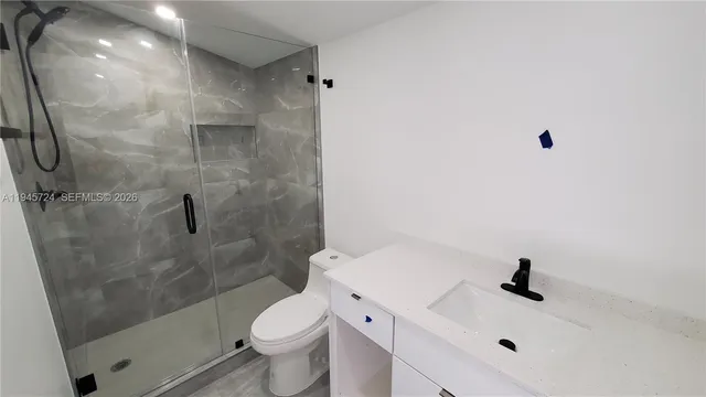 a bathroom with a sink toilet and shower