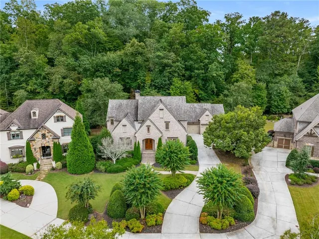 an aerial view of a house with garden space and street view