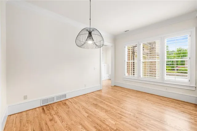 a kitchen with stainless steel appliances granite countertop a stove top oven a sink dishwasher and a refrigerator with wooden floor