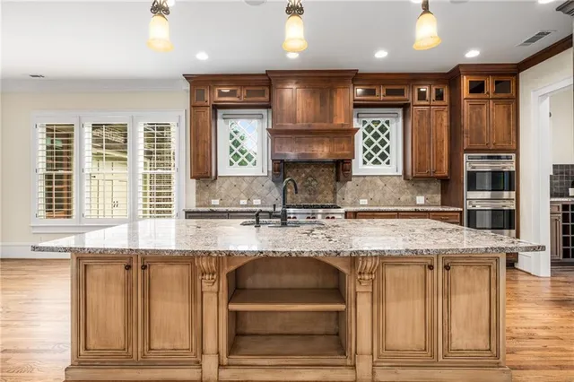 a kitchen with granite countertop a stove and a sink