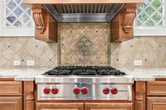a view of an empty room with wooden floor fireplace and a window