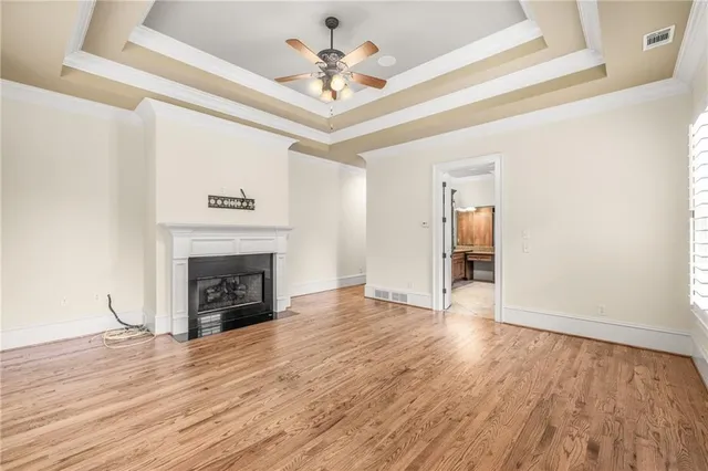 a bathroom with a toilet a sink a mirror a window and vanity