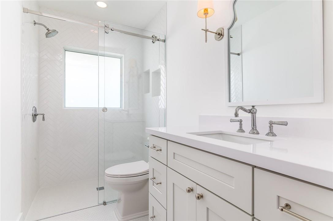 831 Hickory Terrace Boca Raton, FL 33486 - Photo 12 of 25 a bathroom with a granite countertop sink toilet and shower