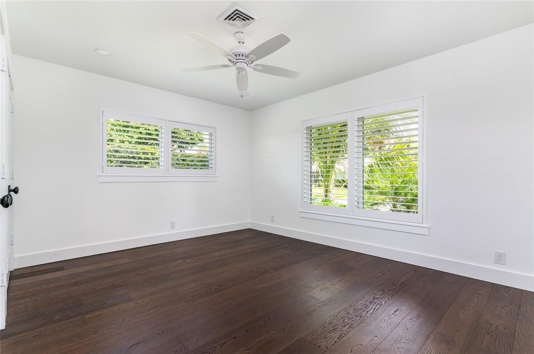831 Hickory Terrace Boca Raton, FL 33486 - Photo 15 of 25 a view of an empty room with wooden floor and a window
