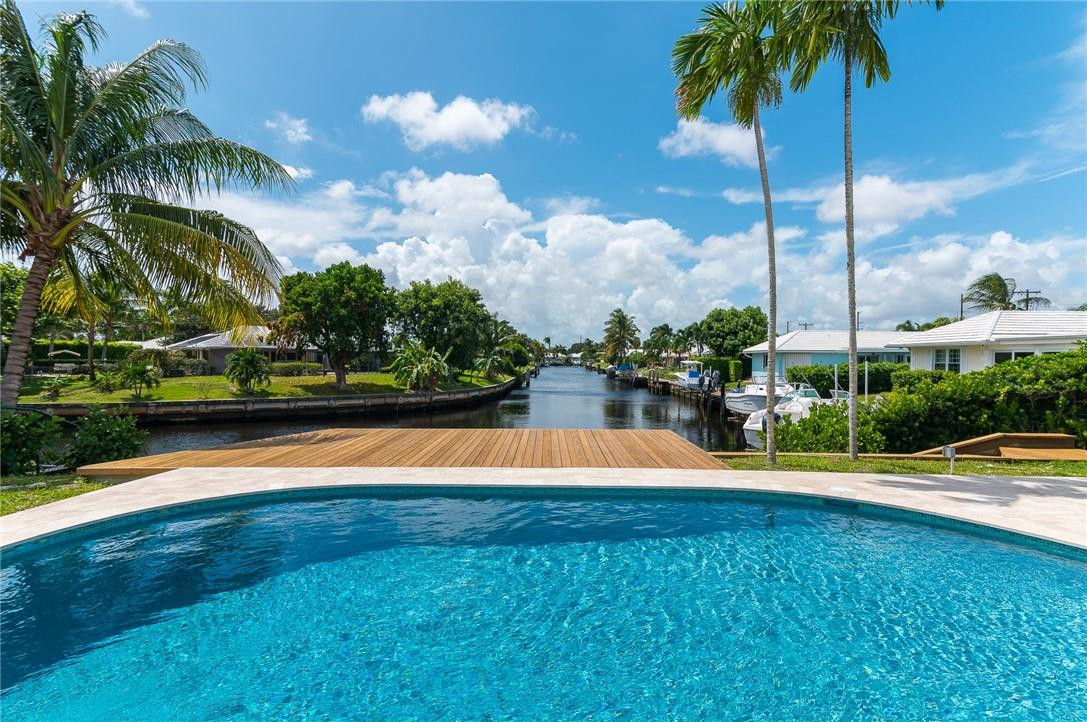 831 Hickory Terrace Boca Raton, FL 33486 - Photo 19 of 25 a view of swimming pool with a yard and palm trees