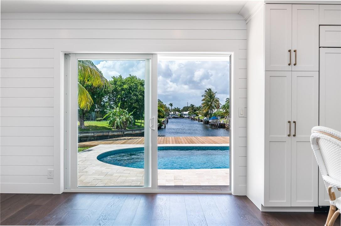 831 Hickory Terrace Boca Raton, FL 33486 - Photo 5 of 25 a view of a porch with wooden floor and front door