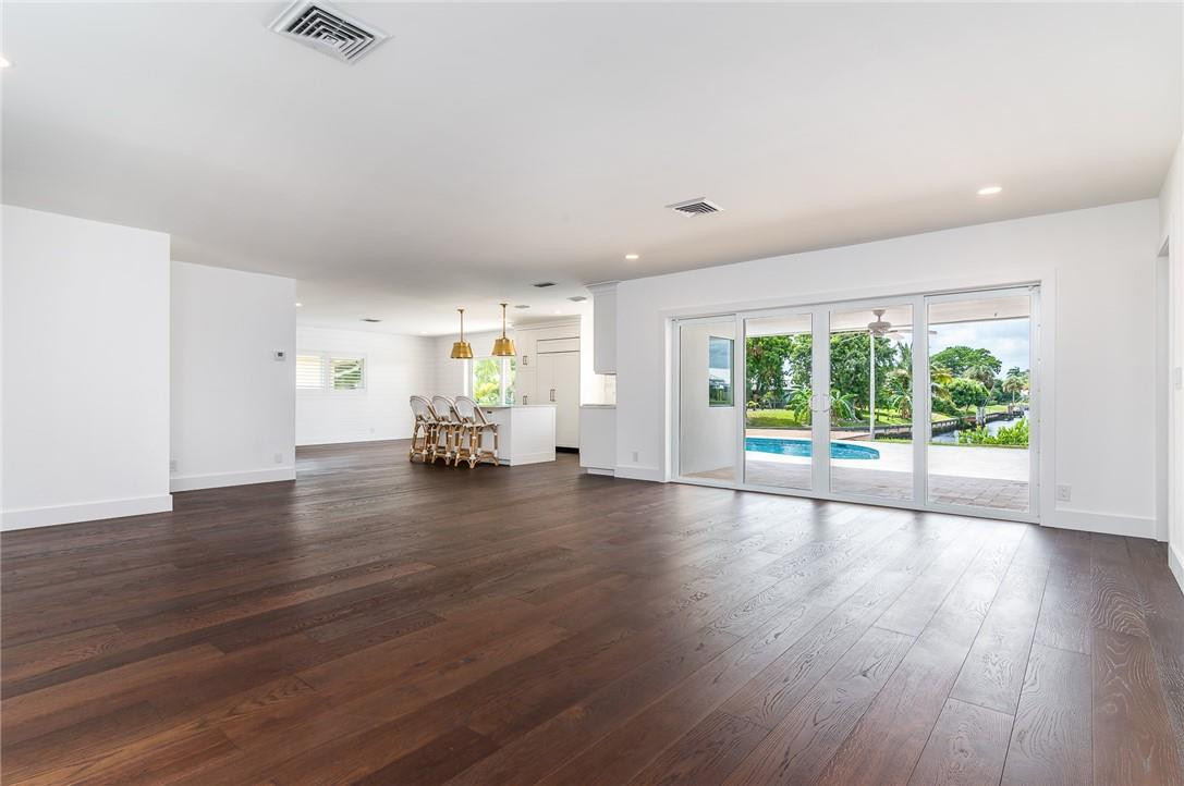 831 Hickory Terrace Boca Raton, FL 33486 - Photo 6 of 25 a view of empty room with wooden floor and fan