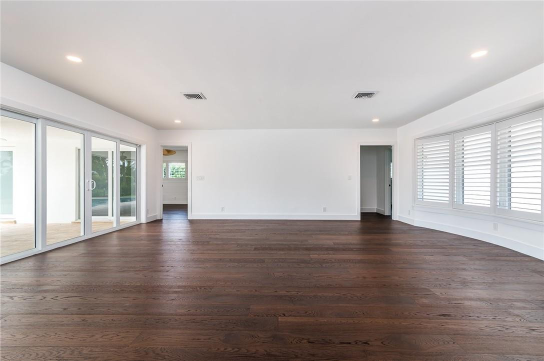 831 Hickory Terrace Boca Raton, FL 33486 - Photo 8 of 25 a view of an empty room with wooden floor and a window