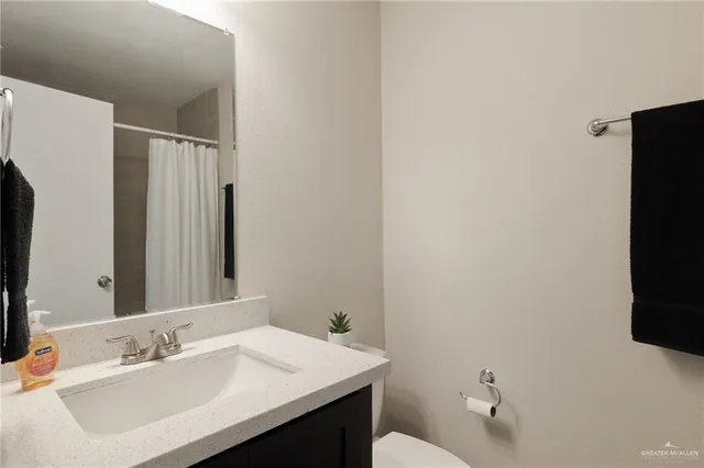 a bathroom with a sink toilet and mirror