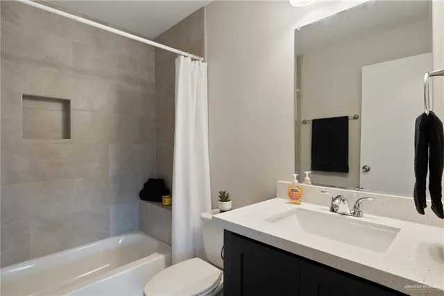 a bathroom with a sink toilet and tub