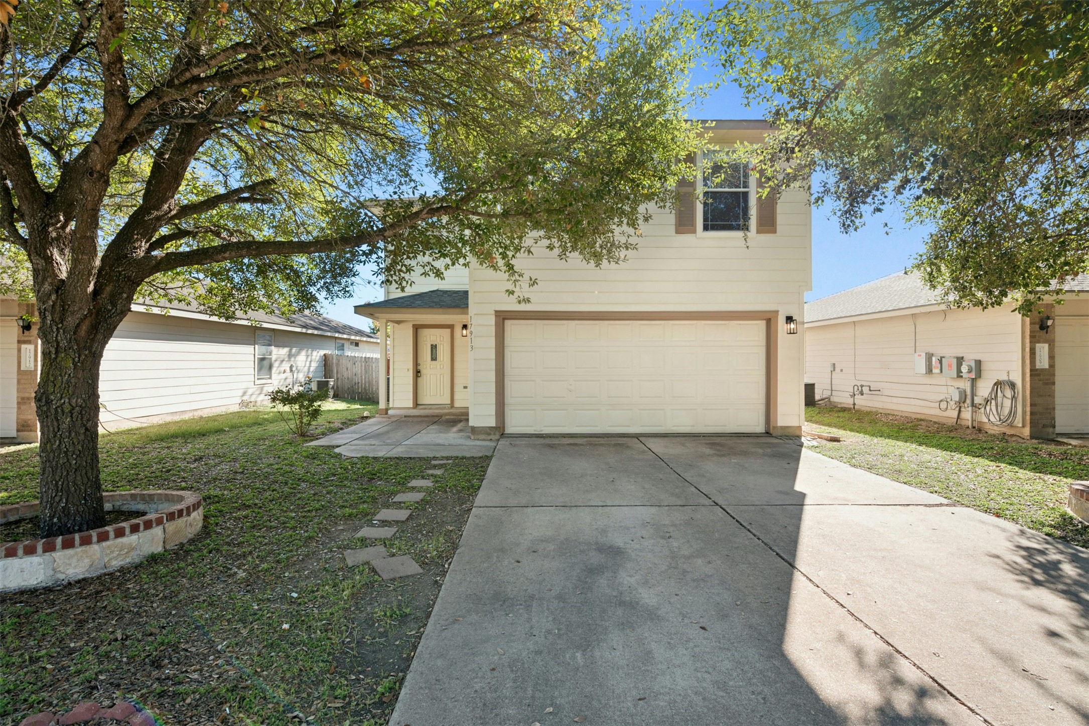 17913 Honey Locust Lane Elgin, TX 78621 - Photo 1 of 1 a view of a white house next to a yard with a large tree