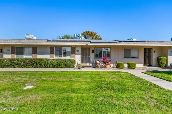 a view of a house with backyard porch and sitting area