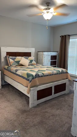 a bedroom with a bed and window