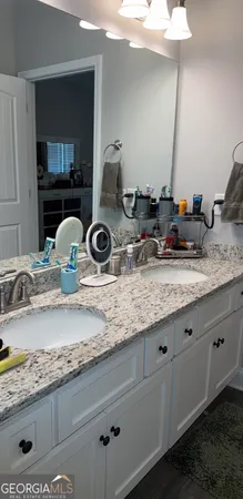 a bathroom with sink and mirror