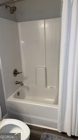 a bathroom with a toilet and a bathtub