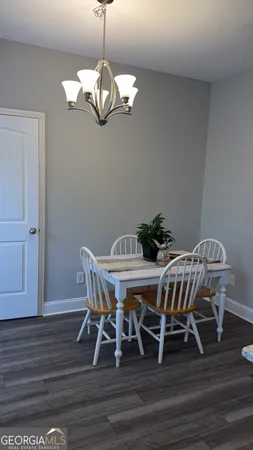 a view of a dining room with furniture wooden floor and chandelier