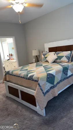 a bedroom with a bed and a mirror