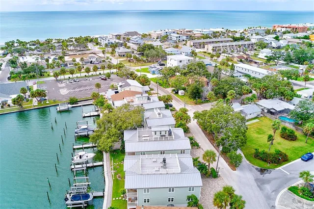 a view of an ocean with boats and trees in the background