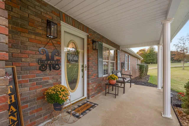 a front view of a house with outdoor seating