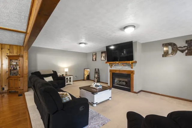 a living room with fireplace furniture and a flat screen tv