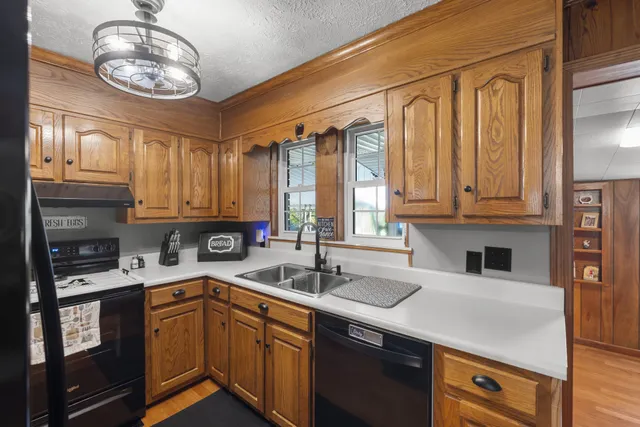 a kitchen with stainless steel appliances granite countertop a sink and cabinets