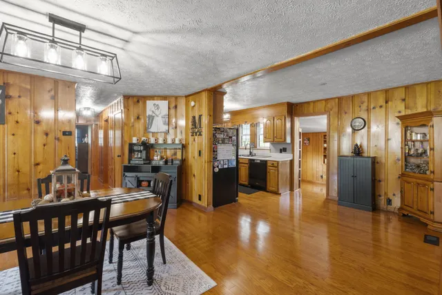 a view of a dining room with furniture a chandelier and wooden floor