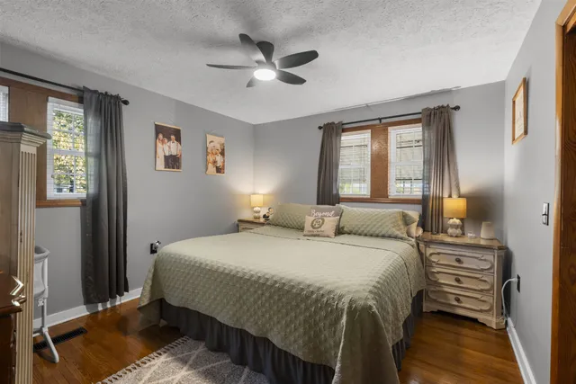 a bedroom with a bed and a chandelier