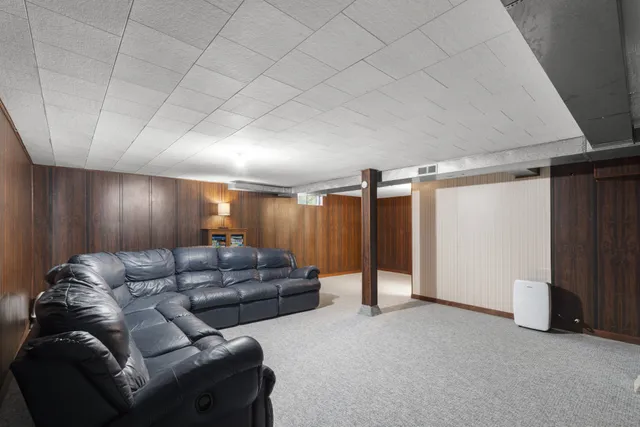 a living room with furniture and a glass door
