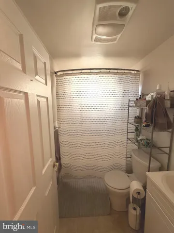 a bathroom with a toilet and a shower